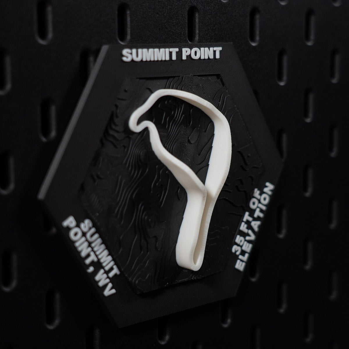 Summit Point hex angled, white lap in relief with 35 ft of elevation engraved on the edge