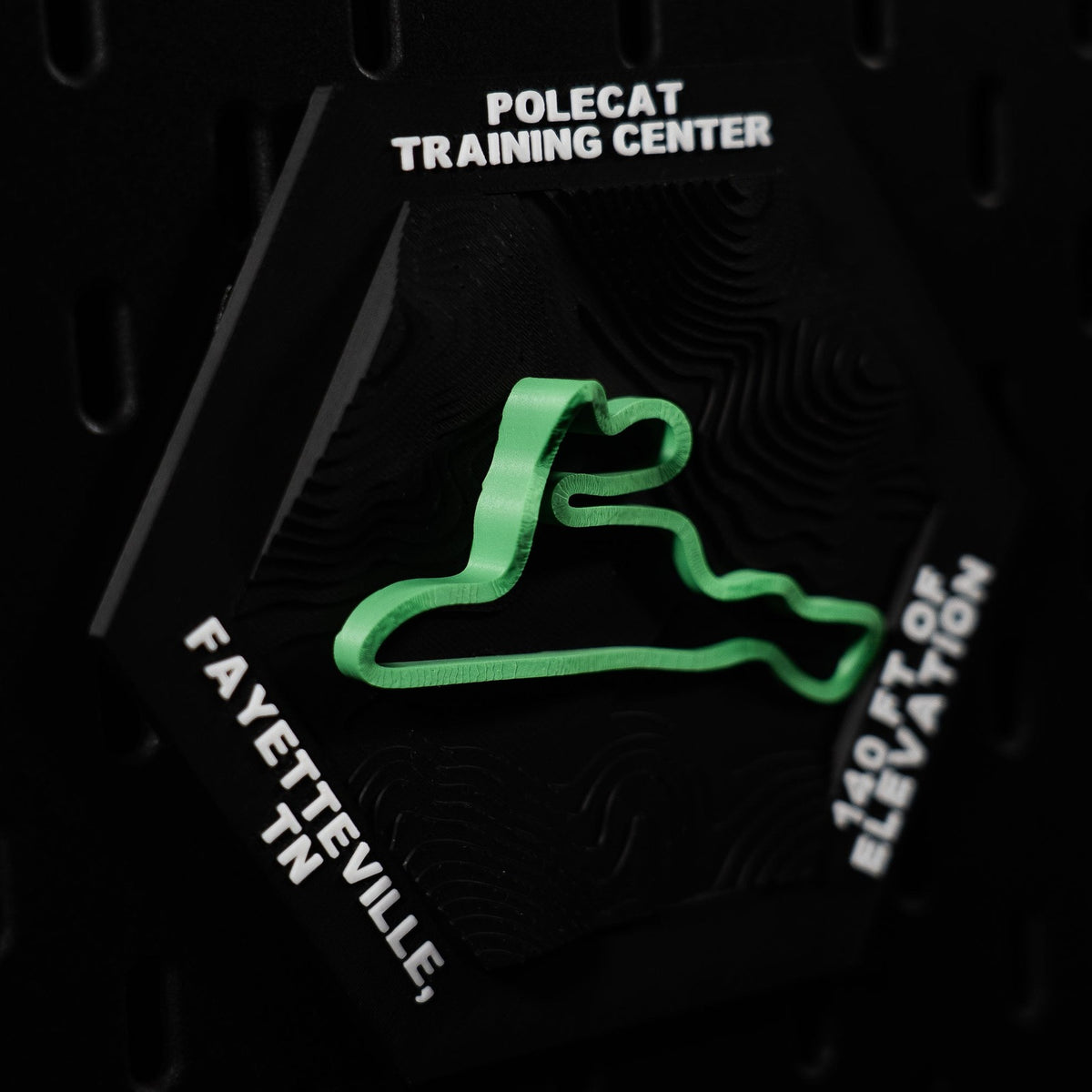 Polecat Training Center hex angled, green loop with Fayetteville, TN engraved on the edge