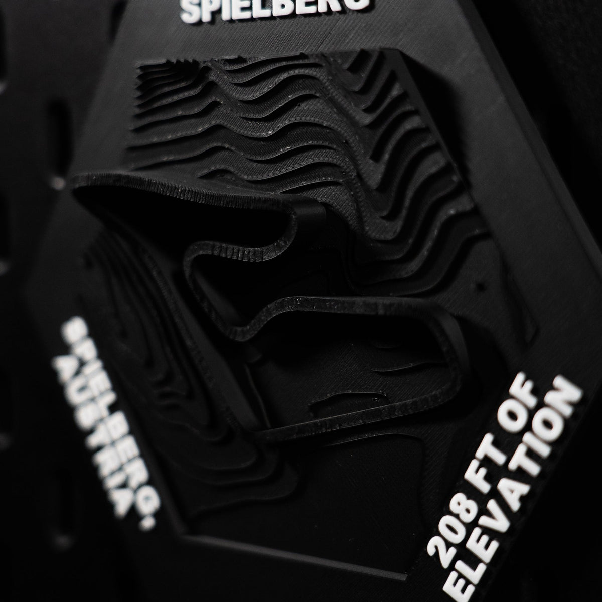 Spielberg hex angled, deep stepped contours dropping away beside the engraved 208 ft of elevation
