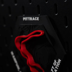 PittRace hex in low light, red circuit half in shadow beneath the engraved header