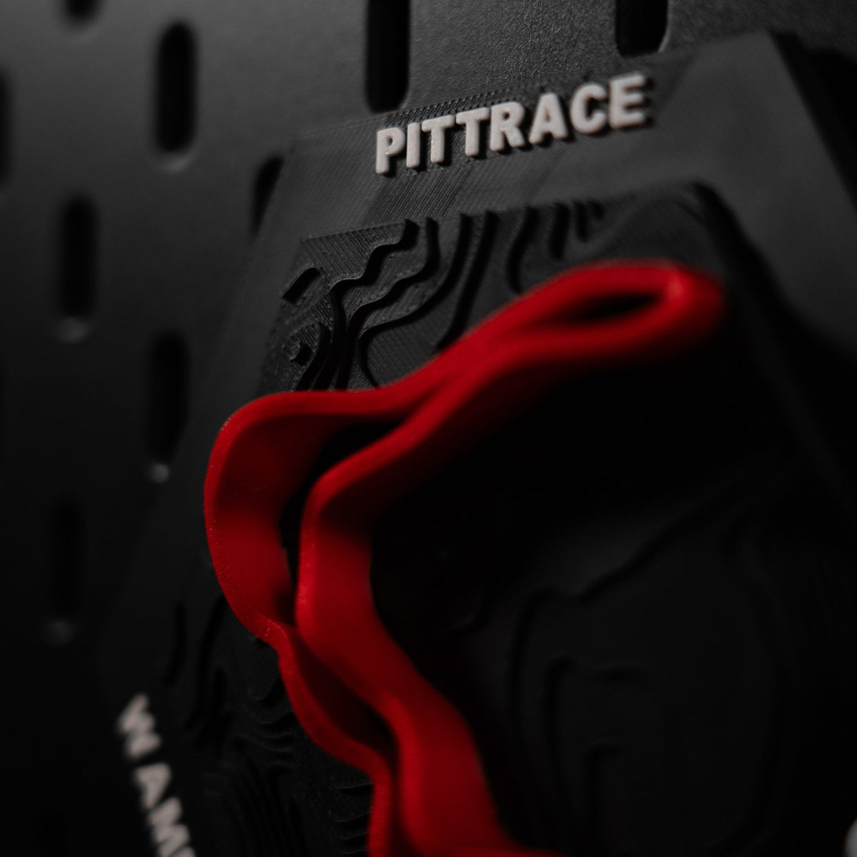 PittRace hex macro, the red ribbon filling the frame with the hex edge behind