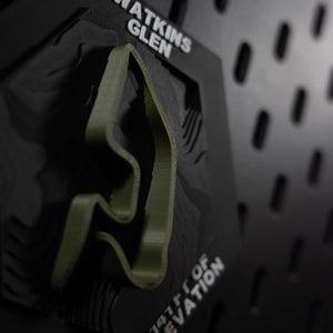 Watkins Glen hex angled, olive lap in relief above engraved Watkins Glen, NY