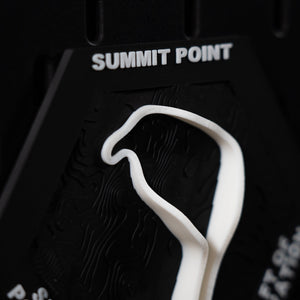 Summit Point hex close crop, white circuit curving under the engraved header lettering