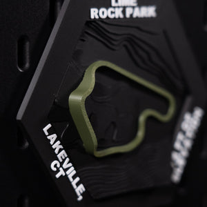 Lime Rock Park hex angled left, olive loop above bold white lettering reading Lakeville, CT