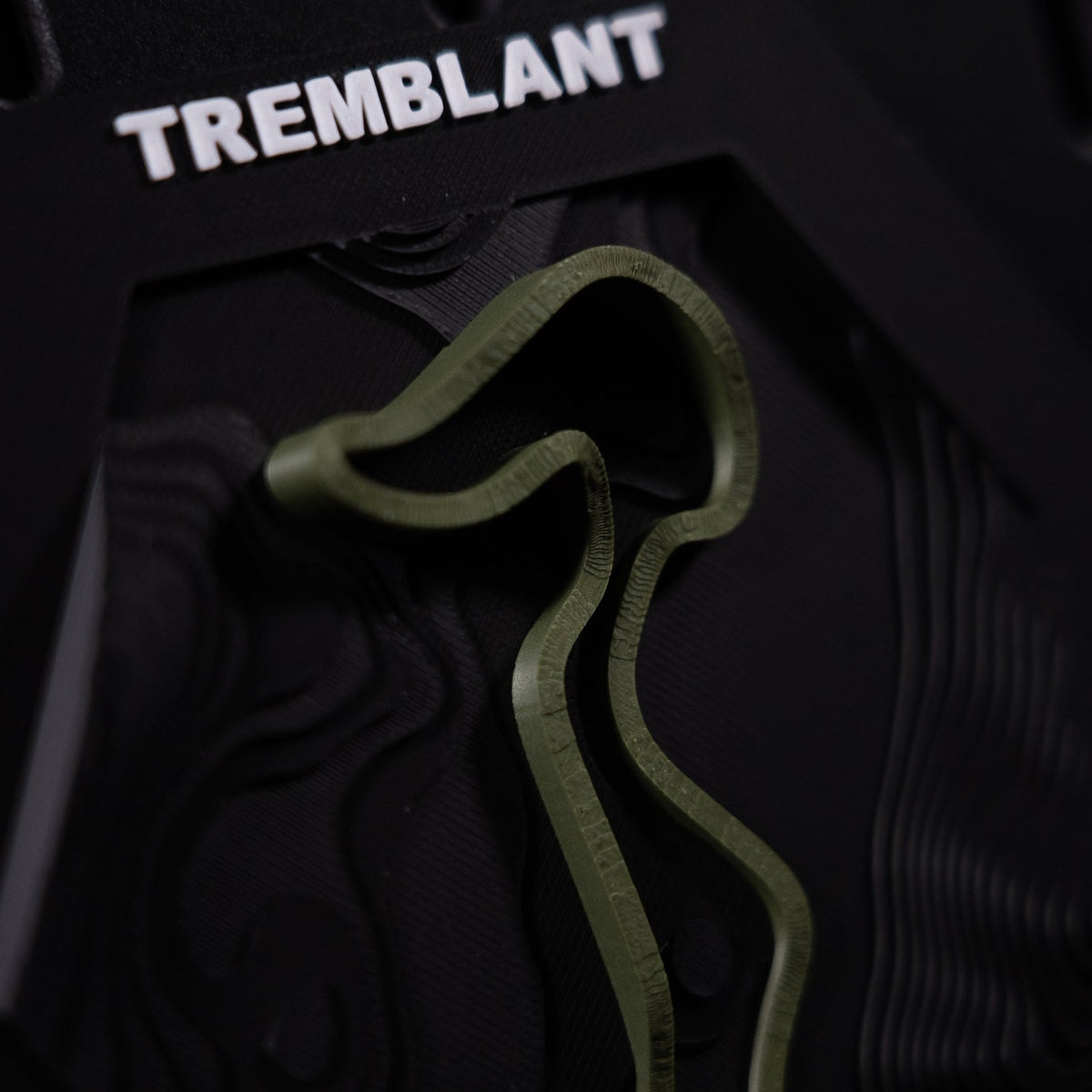Mont-Tremblant hex macro, the olive ribbon and its long hairpin filling the frame