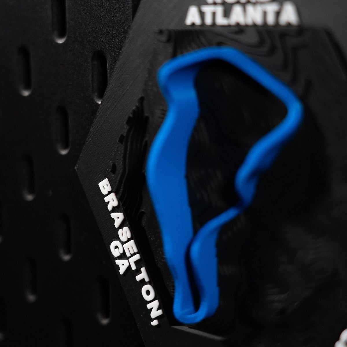 Road Atlanta hex cropped tight on engraved Braselton, GA with the blue loop soft behind