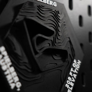 Spielberg hex at a raking angle, stacked print layers reading as bare contour lines