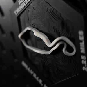 NJMP Thunderbolt hex angled, white lap in relief beside the engraved 2.25 miles