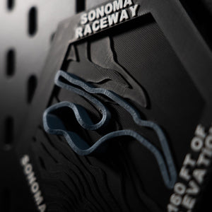 Sonoma Raceway hex at a steep angle, blue track threading heavily terraced hillside contours