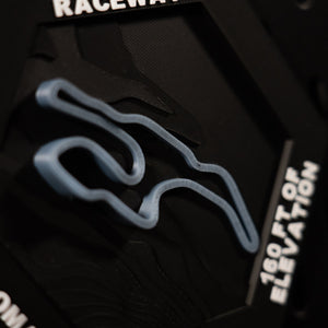 Sonoma Raceway hex from above, blue esses in relief beside the engraved 160 ft of elevation