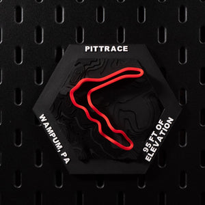 PittRace hex flat on black pegboard, red circuit loop raised over black contour terrain