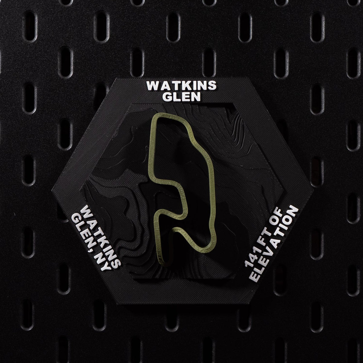 Watkins Glen hex flat on black pegboard, olive green circuit loop over terraced black terrain