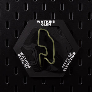 Watkins Glen hex flat on black pegboard, olive green circuit loop over terraced black terrain