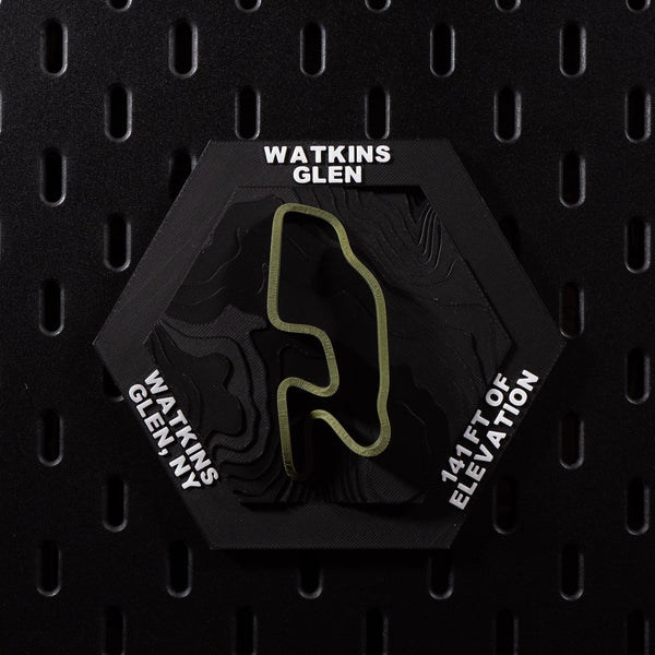 Watkins Glen hex flat on black pegboard, olive green circuit loop over terraced black terrain