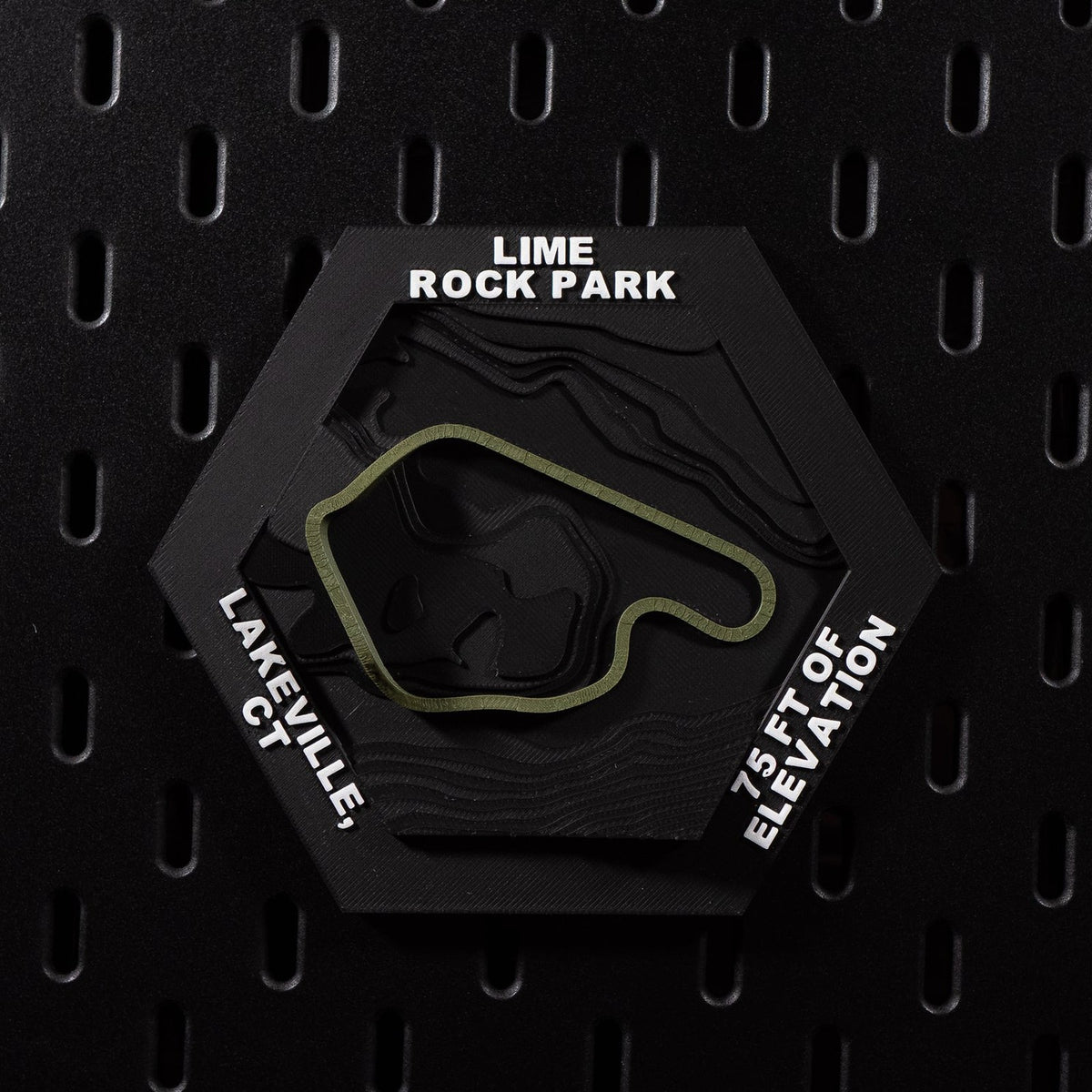 Lime Rock Park hex flat on black pegboard, olive green track loop on terraced black terrain