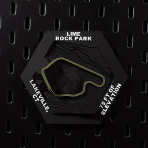 Lime Rock Park hex flat on black pegboard, olive green track loop on terraced black terrain