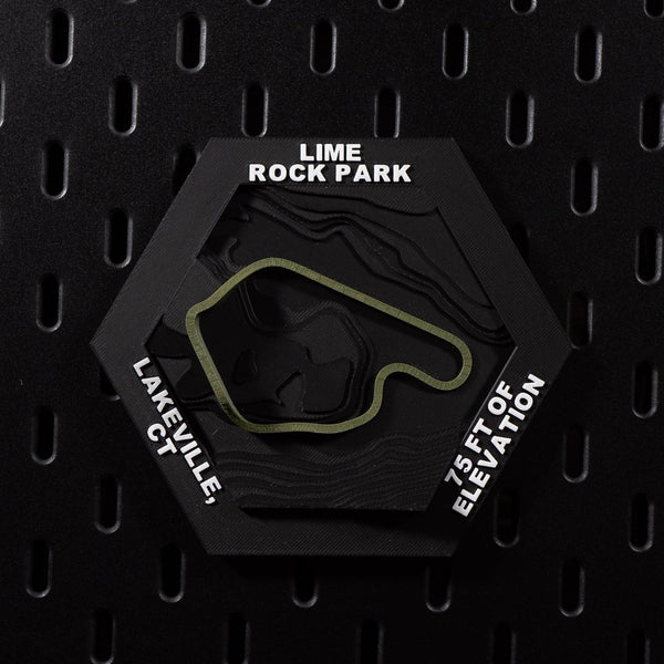 Lime Rock Park hex flat on black pegboard, olive green track loop on terraced black terrain