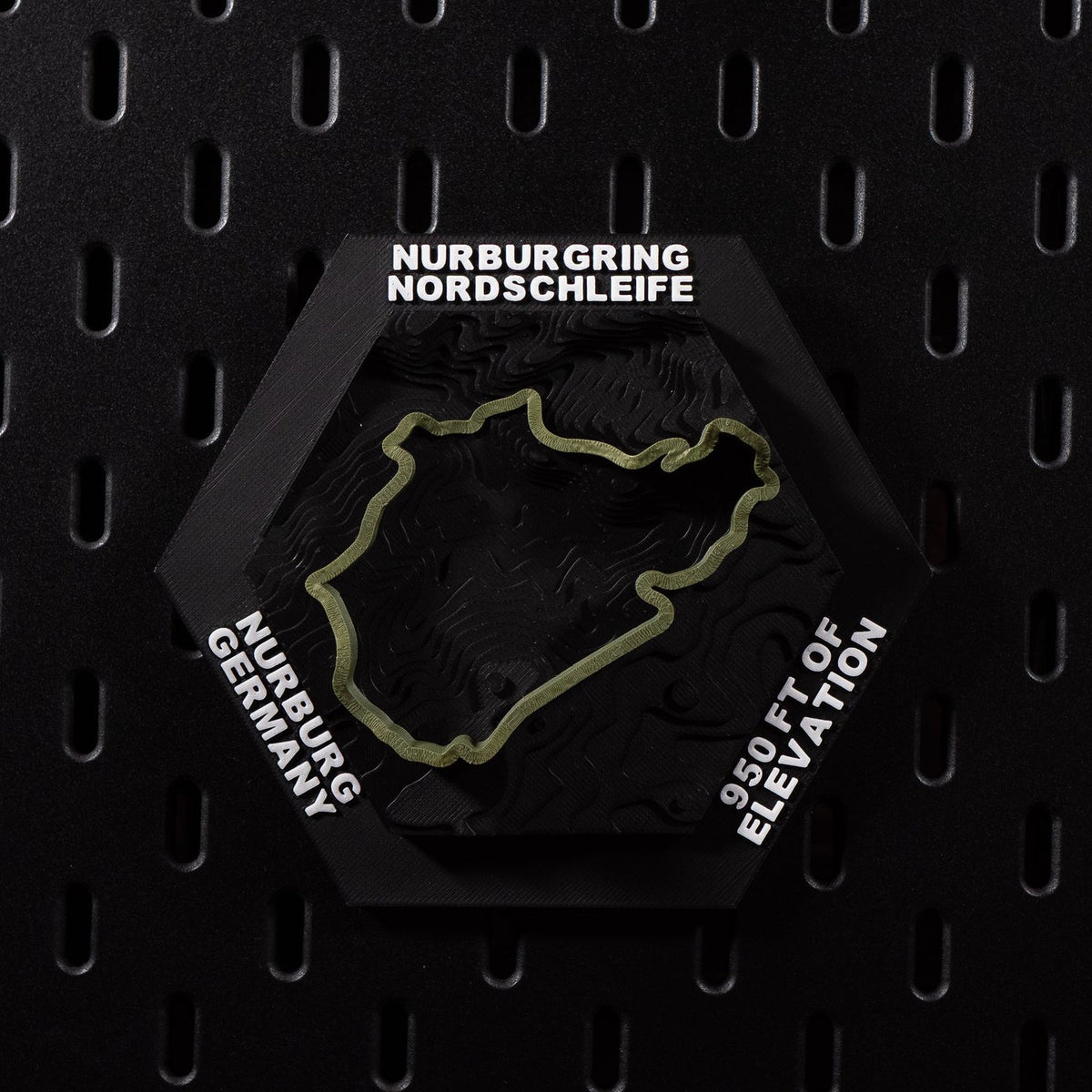 Nürburgring Nordschleife hex flat on black pegboard, olive green lap over terraced terrain