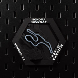 Sonoma Raceway hex flat on black pegboard, steel blue circuit loop on terraced terrain