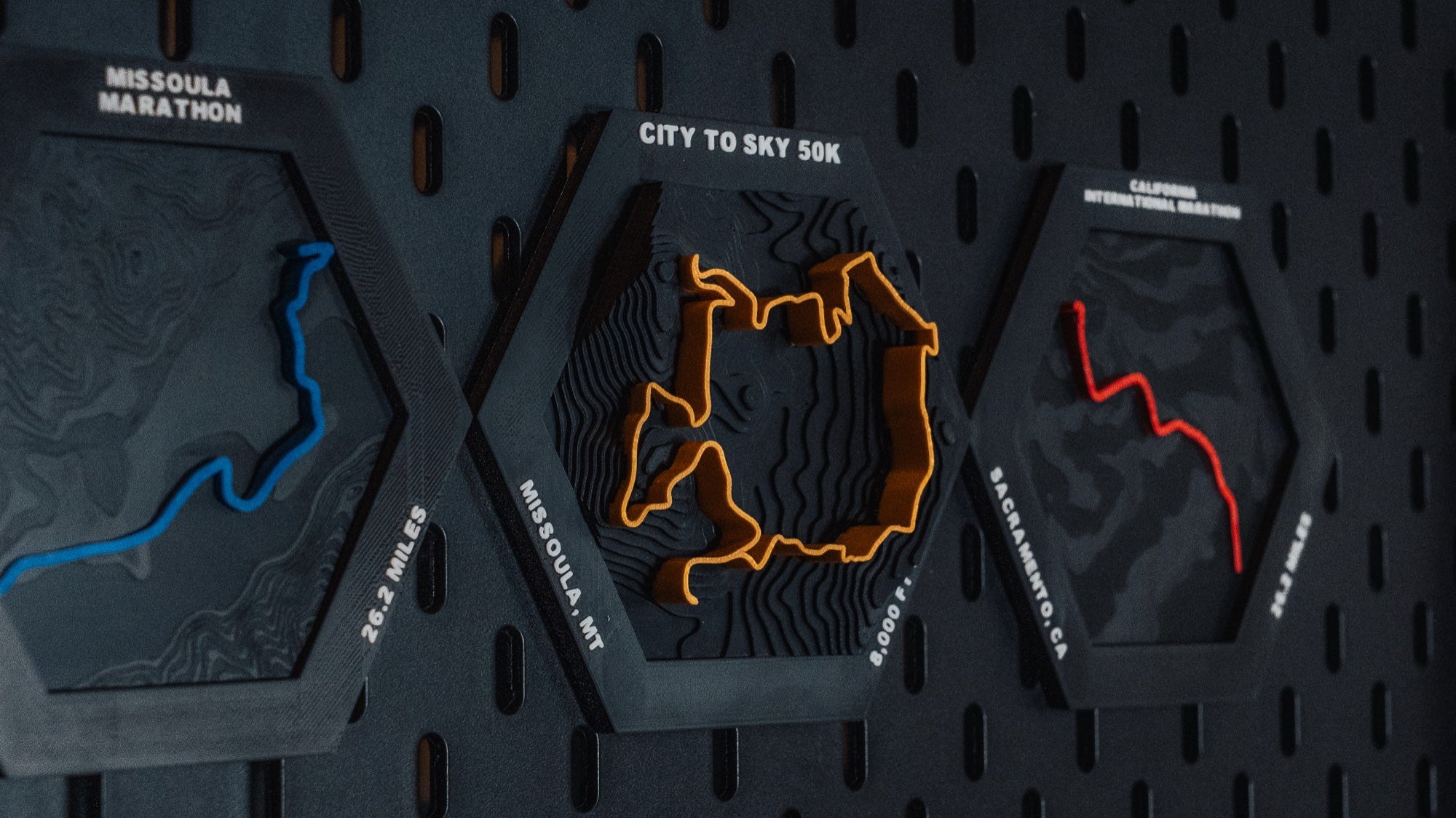 Custom race route hexes on pegboard wall